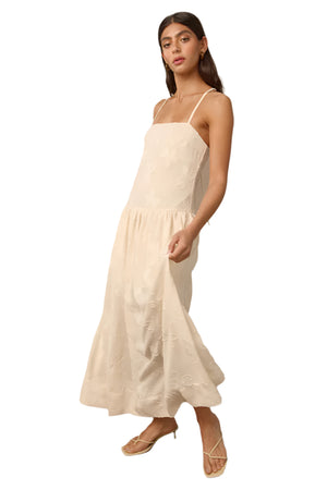 A light weight midi dress with woven fabric, a dropped waist bodice, and tie up straps.